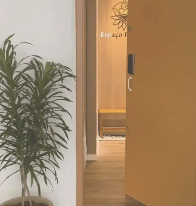 Entrada do Espaço Raygus com porta dourada e logotipo na recepção